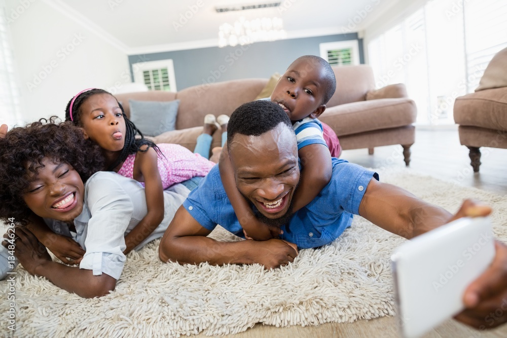 Happy family taking a selfie from mobile phone in living room Happy family taking a selfie from mobile phone in living room