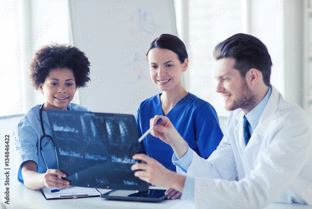 group of happy doctors discussing x-ray image group of happy doctors discussing x-ray image