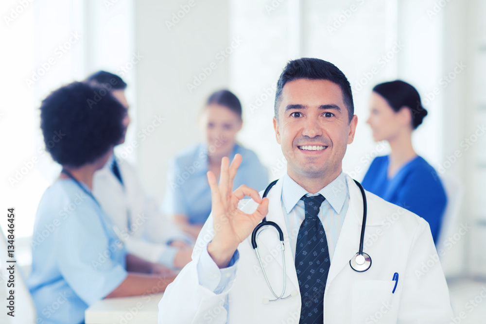 happy doctor over group of medics at hospital happy doctor over group of medics at hospital