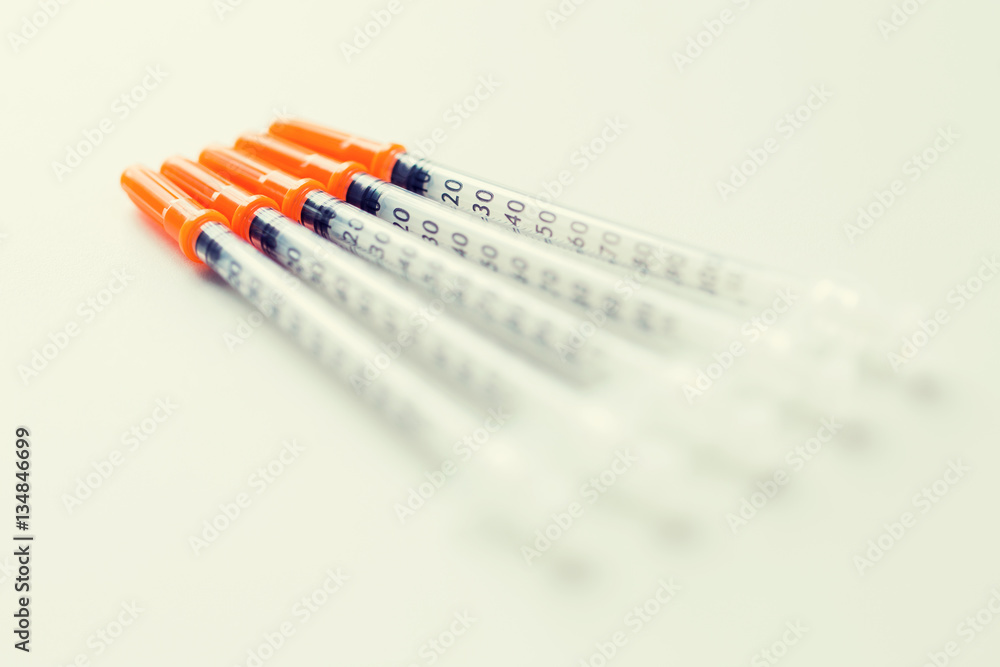 close up of insulin syringes on table close up of insulin syringes on table
