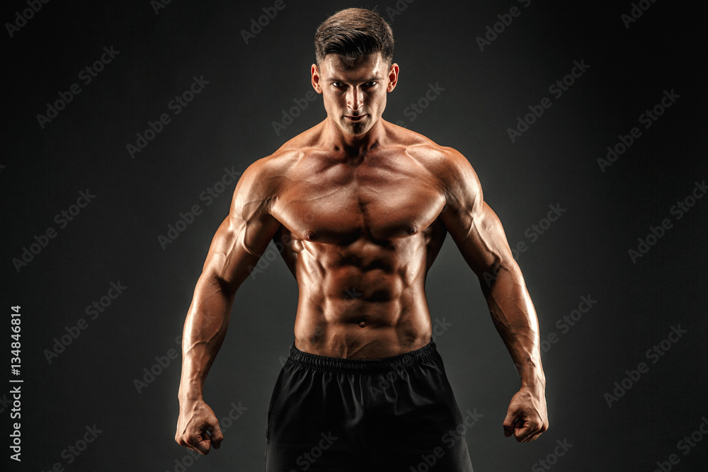 bodybuilder posing. Beautiful sporty guy male power. Fitness muscled man  Stock Photo | Adobe Stock