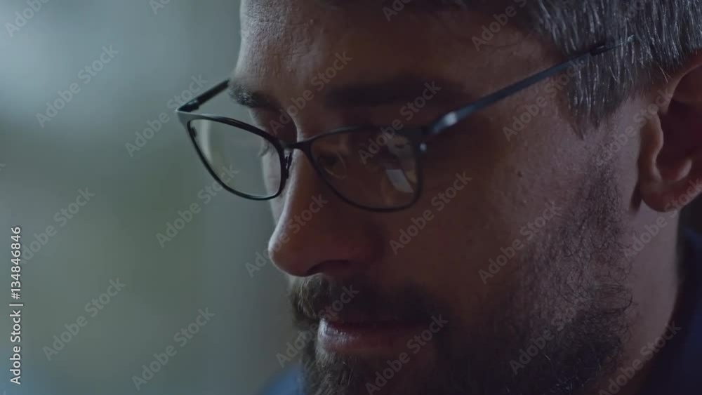 Closeup of bearded businessman in eyeglasses talking on the mobile phone Closeup of bearded businessman in eyeglasses talking on the mobile phone