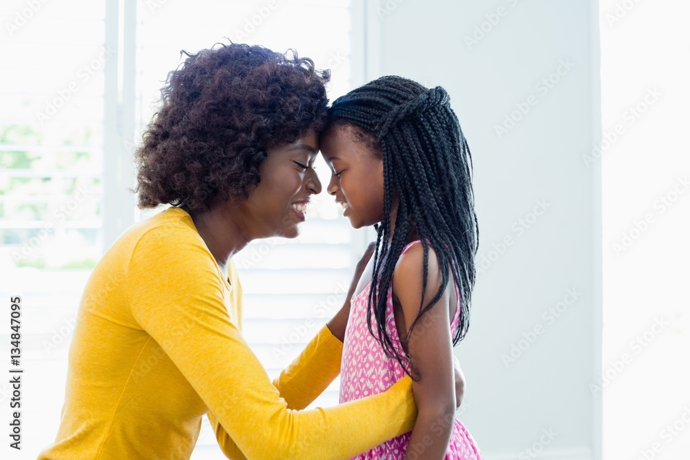 Mother and daughter embracing face to face Mother and daughter embracing face to face