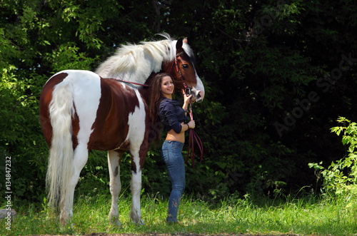 Young cowgirl with horse summer outdoor © horsemen