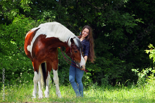 Young cowgirl with horse outdoor