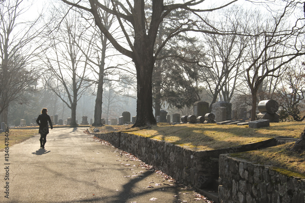 woman walking in cemetery