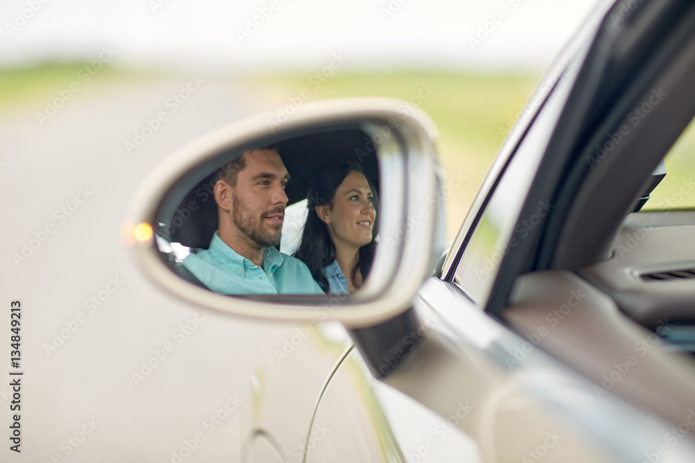 side mirror reflection of happy couple driving car side mirror reflection of happy couple driving car
