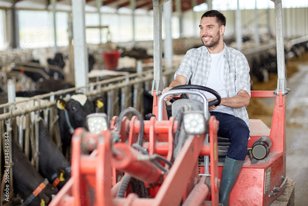 man or farmer driving tractor at farm man or farmer driving tractor at farm