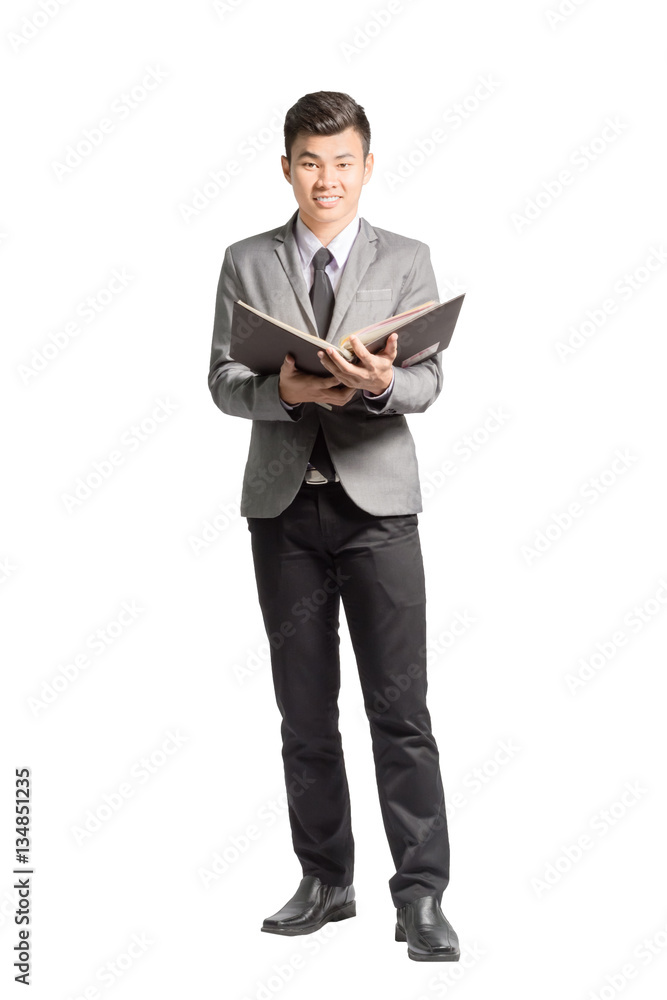 Portrait of a young business man reading annual report. Isolated Portrait of a young business man reading annual report. Isolated