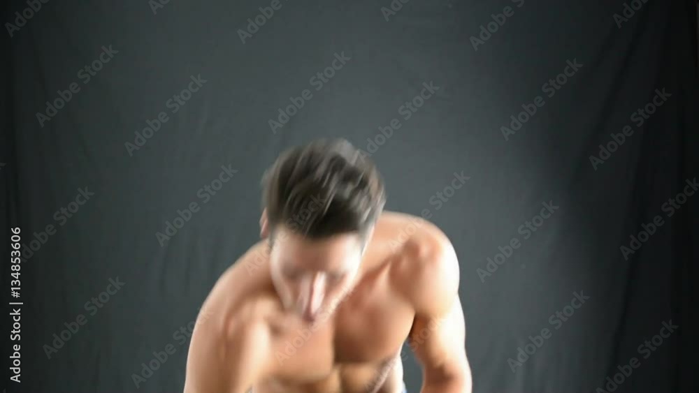 Handsome Muscular Shirtless Young Man Applying Oil or Lotion to his Skin. Showing Healthy Fit Body Handsome Muscular Shirtless Young Man Applying Oil or Lotion to his Skin. Showing Healthy Fit Body