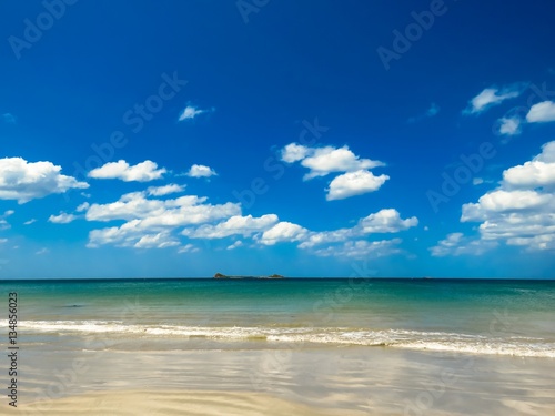 Fototapeta Naklejka Na Ścianę i Meble -  View of Pigeon Island Trincomalee from Beautiful White Sand turquoise water breaking waves and Beach with Blue Sky with White clouds