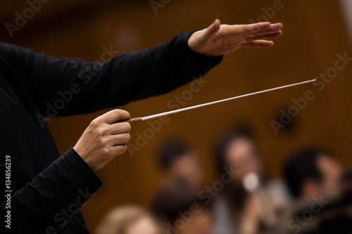 Hands of conductor closeup in dark colors