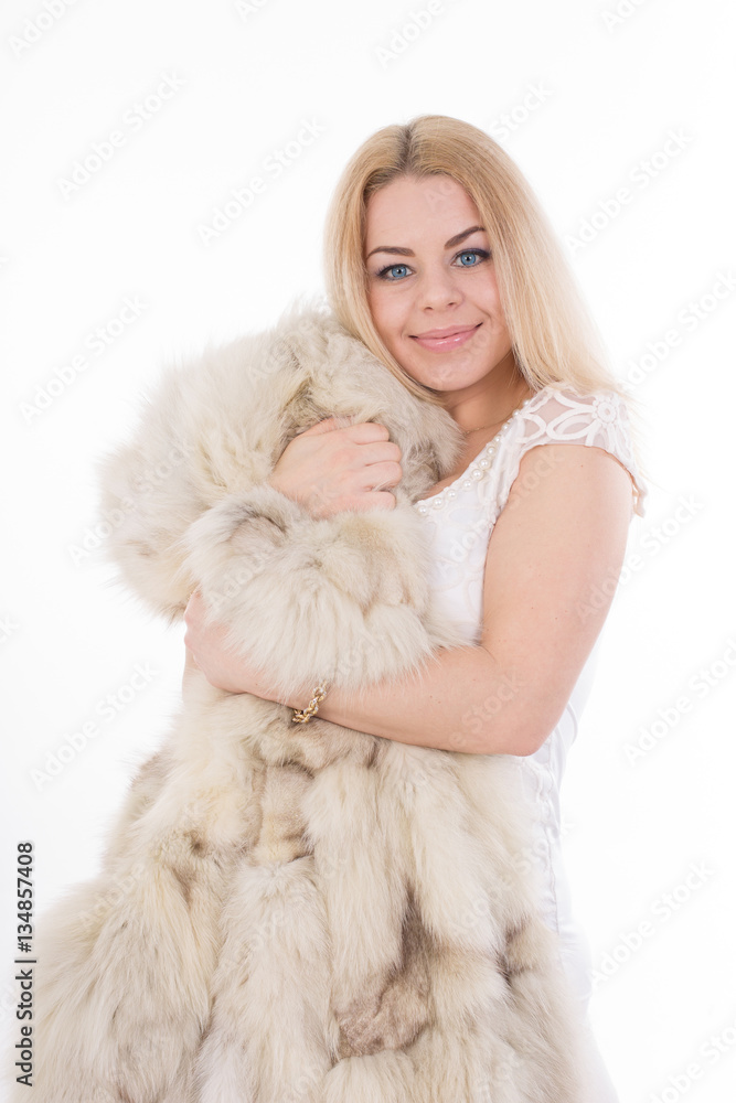 Blond girl with fur coat on white background, isolated. Studio portrait Blond girl with fur coat on white background, isolated. Studio portrait