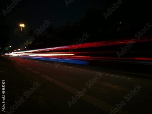 Car light trails on the road, movement in Thailand.