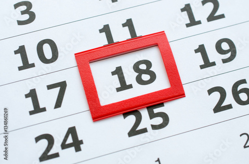White paper calendar with the number 18 in the red box