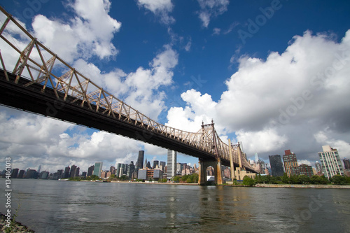 Queensboro bridge over water and builings in Manhattan photo