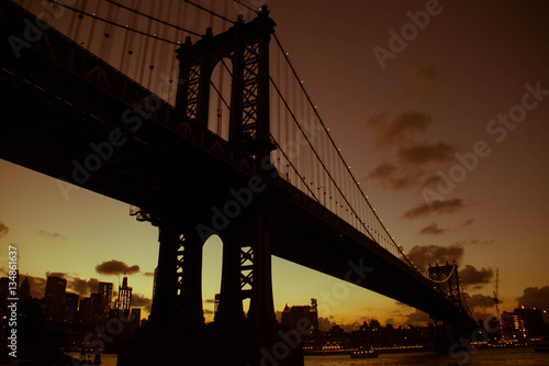 Manhattan bridge in silhouette in orange vintage color style