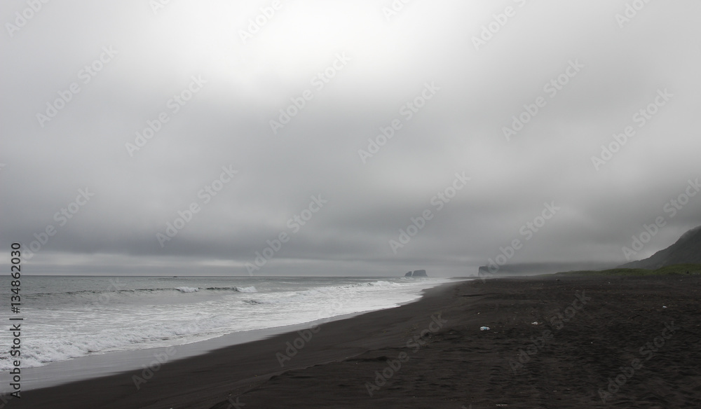 Khalaktyrsky beach with black volcanic sand near Petropavlovsk-Kamchatsky. Pacific ocean, Kamchatka peninsula, Russia.