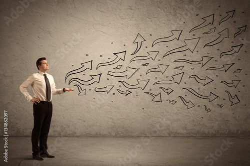 Business man holding arrow signs