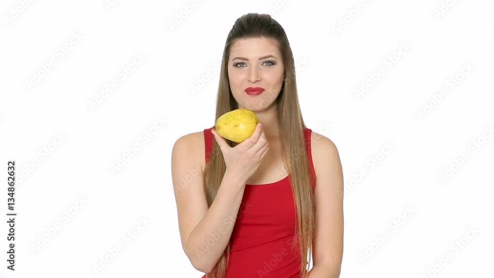 beautiful girl eats ripe pear on white background beautiful girl eats ripe pear on white background