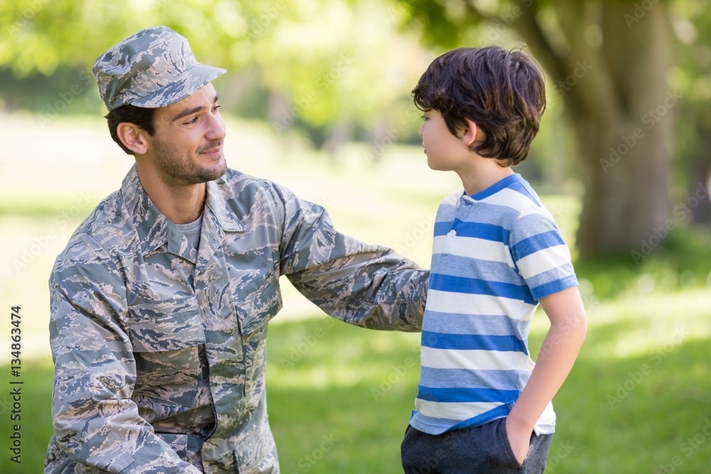 Army soldier interacting with boy