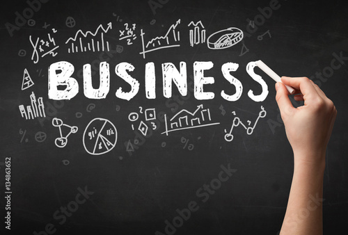 Hand writing business on blackboard