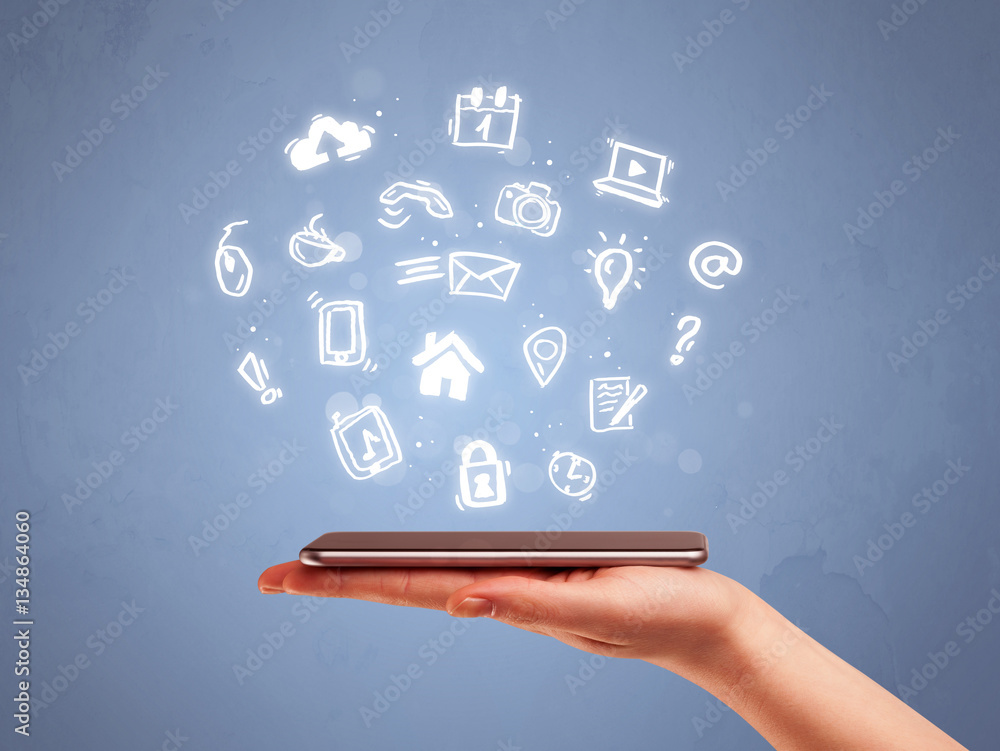 Hand holding tablet phone with drawn icons Hand holding tablet phone with drawn icons