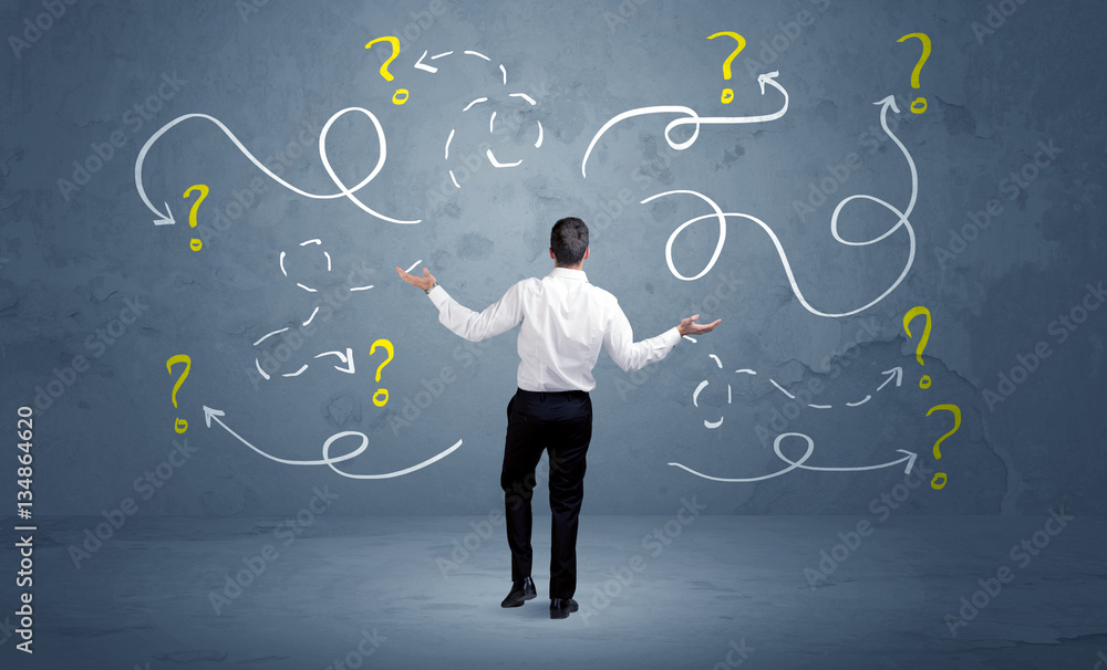 Unsure businessman with question marks Unsure businessman with question marks