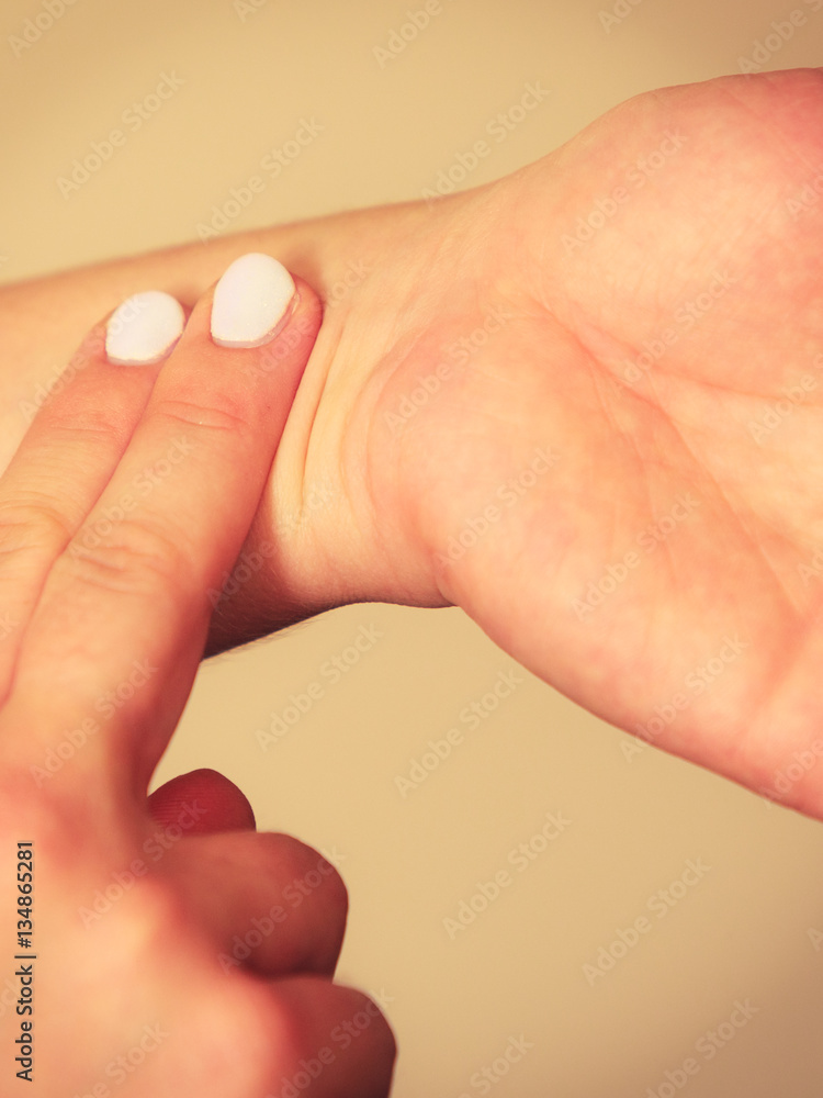 Woman checking pulse on wrist closeup Woman checking pulse on wrist closeup