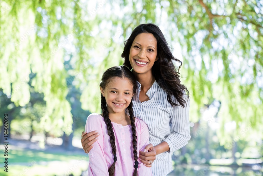 Mother standing with her daughter in park Mother standing with her daughter in park