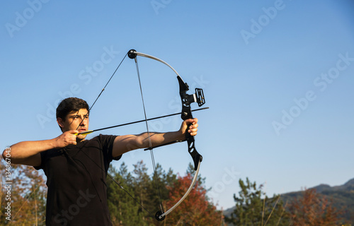 Archer draws his compound bow