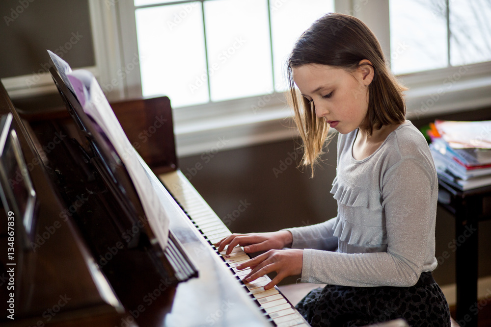 Teenage girl playing piano Stock Photo | Adobe Stock