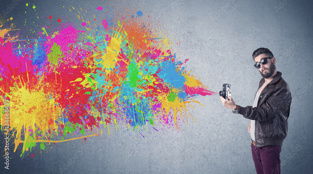 Hipster guy with camera and paint splash Hipster guy with camera and paint splash