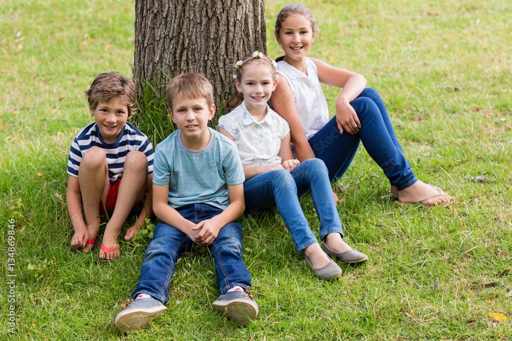 Fototapeta premium Smiling kids relaxing in park