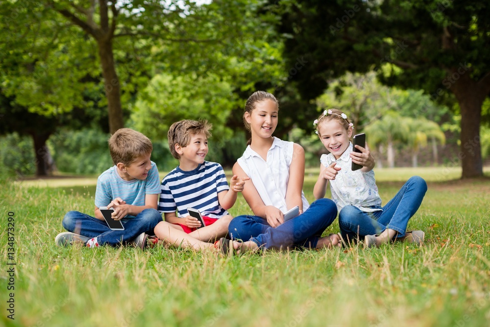 Girl showing photos on mobile phone to her friends Girl showing photos on mobile phone to her friends