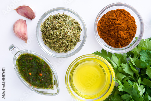 Green Chimichurri Sauce and ingredients isolated on white background
