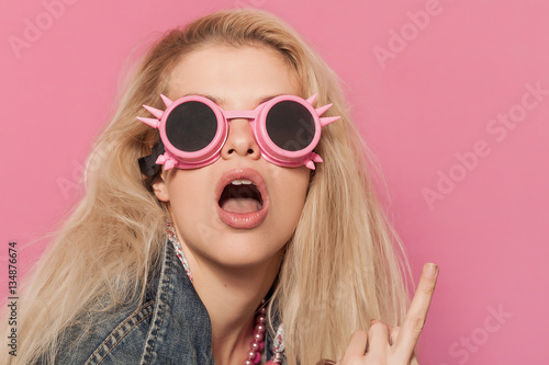 Barbie pop girl wearing odd sunglasses and making middle finger © patronestaff