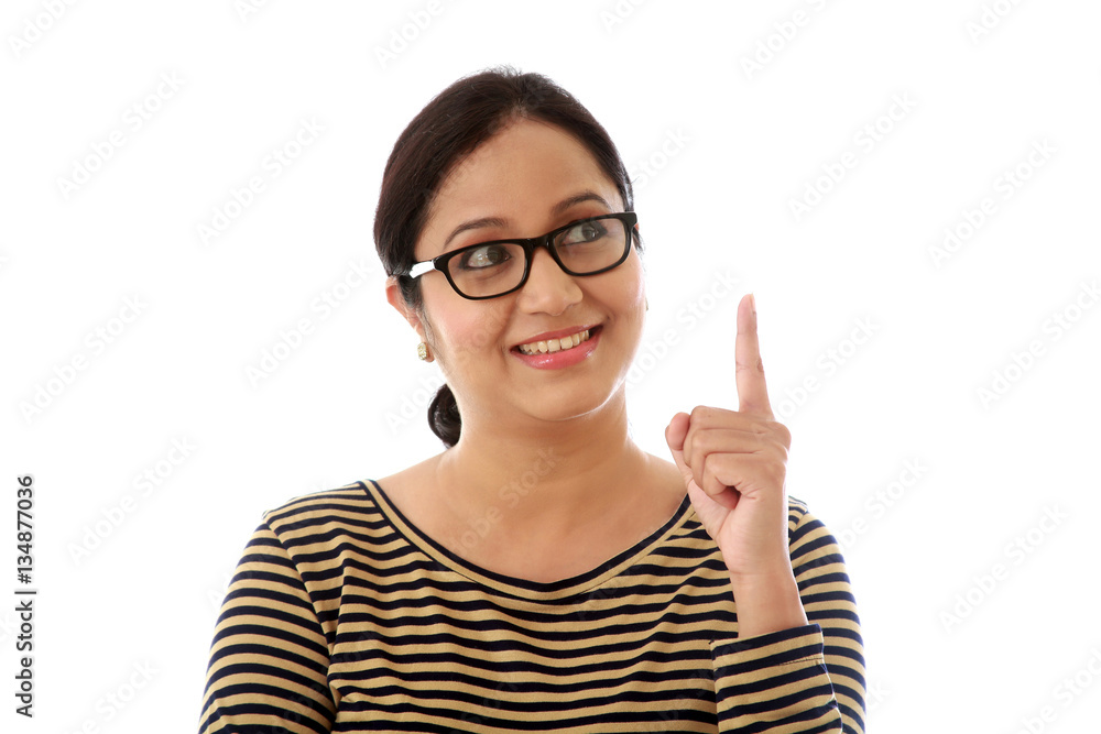 Happy woman pointing at copy space against white background Happy woman pointing at copy space against white background