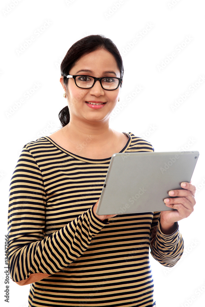 Young happy Woman using a tablet computer against white backgrou Young happy Woman using a tablet computer against white backgrou