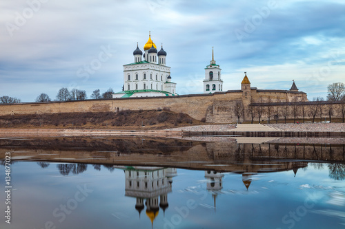 Pskov Kremlin fortress. Cathedral reflection in the river. Long exposure