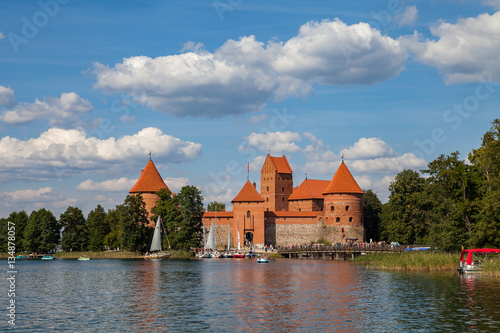 TRAKAI, LITHUANIA - 22 AUG 2015: Unidentified people enjoy boat trip at Galve lake at summer day, tourists walking to Trakai castle