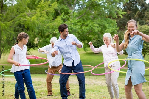 Multi-generation family playing with hula hoop photo
