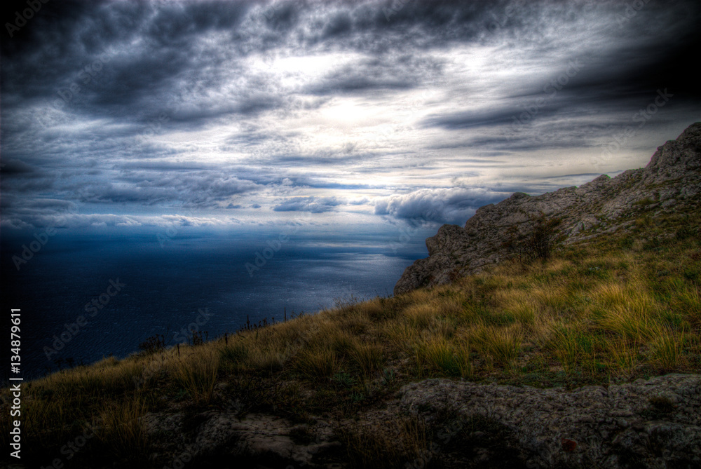 Clouds over the sea before the storm in mountains Clouds over the sea before the storm in mountains