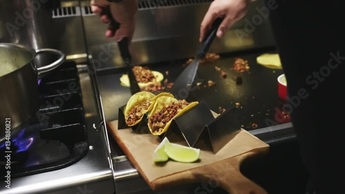 Chef cooking delicious mexican tacos in a restaurant.