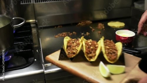 Chef cooking delicious mexican tacos in a restaurant.