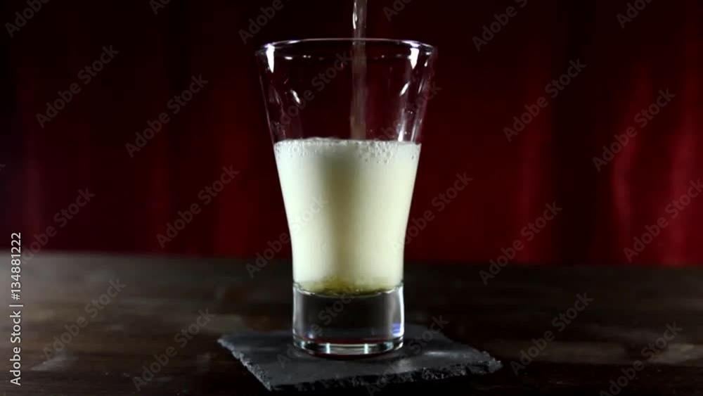 Glass filled with beer from above on wooden table Glass filled with beer from above on wooden table