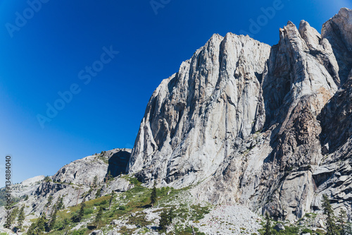Towering granite mountains surround a deep forested valley in California's Sierra Nevada
