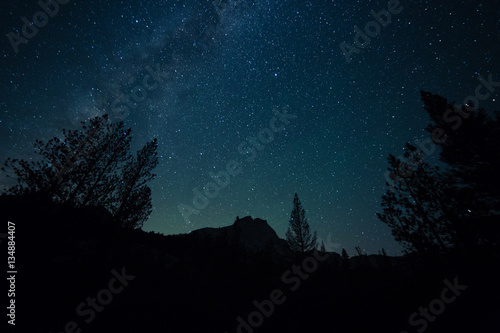 Milky way rises over the forest and mountains of California's high sierra
