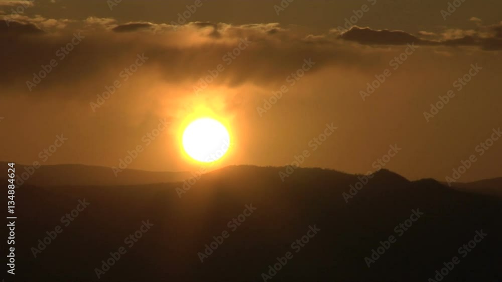 Sun Sinking in the Mountain West Through Clouds Sun Sinking in the Mountain West Through Clouds
