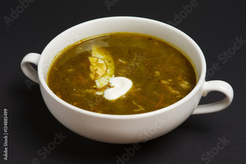 pickle soup with egg and sour cream on black background